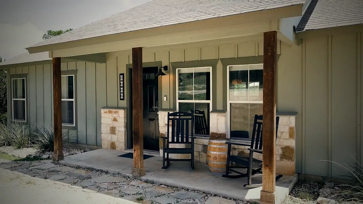 The covered front porch with rocking chairs in warm afternoon light